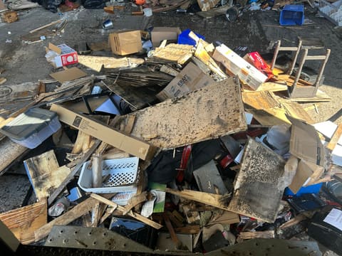 A large pile of broken wood and renovation debris