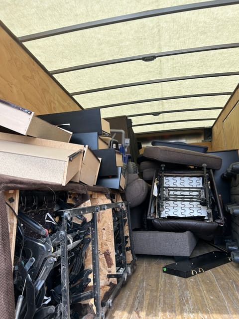Chairs, a recliner and boxes loaded in a truck