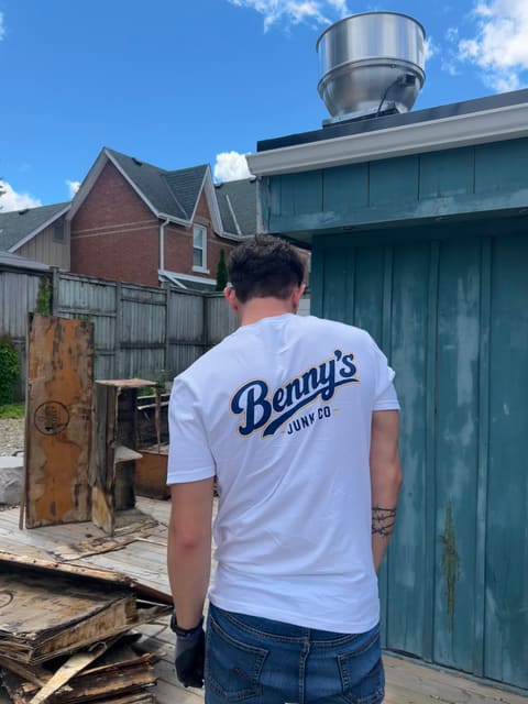 Benny in his Benny's Junk Co shirt, clearing out an old shed