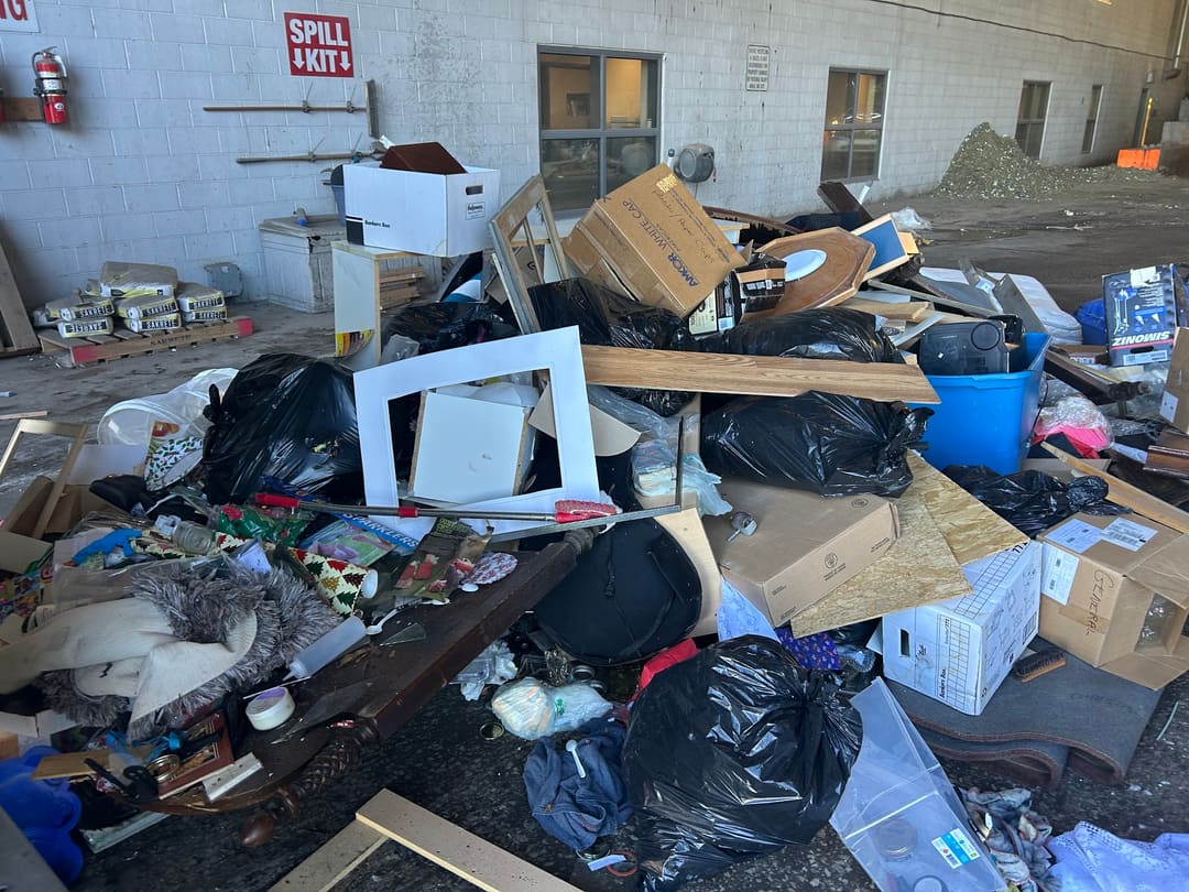 Bags, boxes and debris spread across a commercial back lot