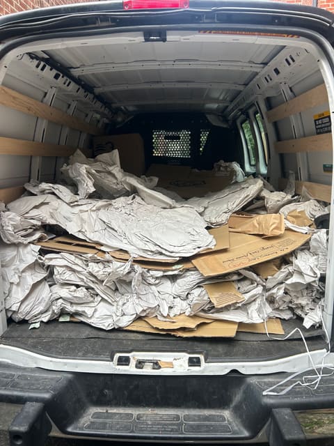 A van filled with cardboard and packing paper after a move