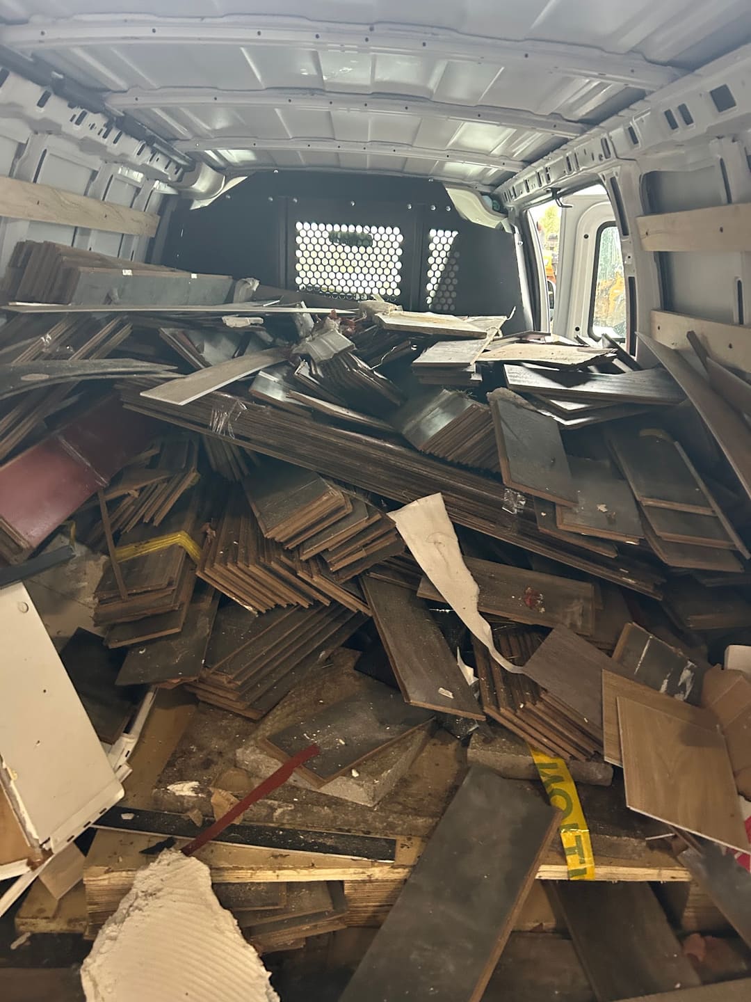Broken wood and drywall from a renovation loaded in a van