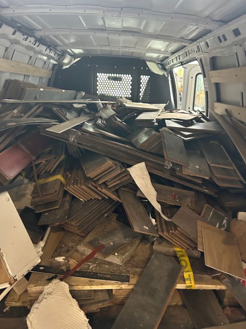 Broken wood and drywall from a renovation loaded in a van