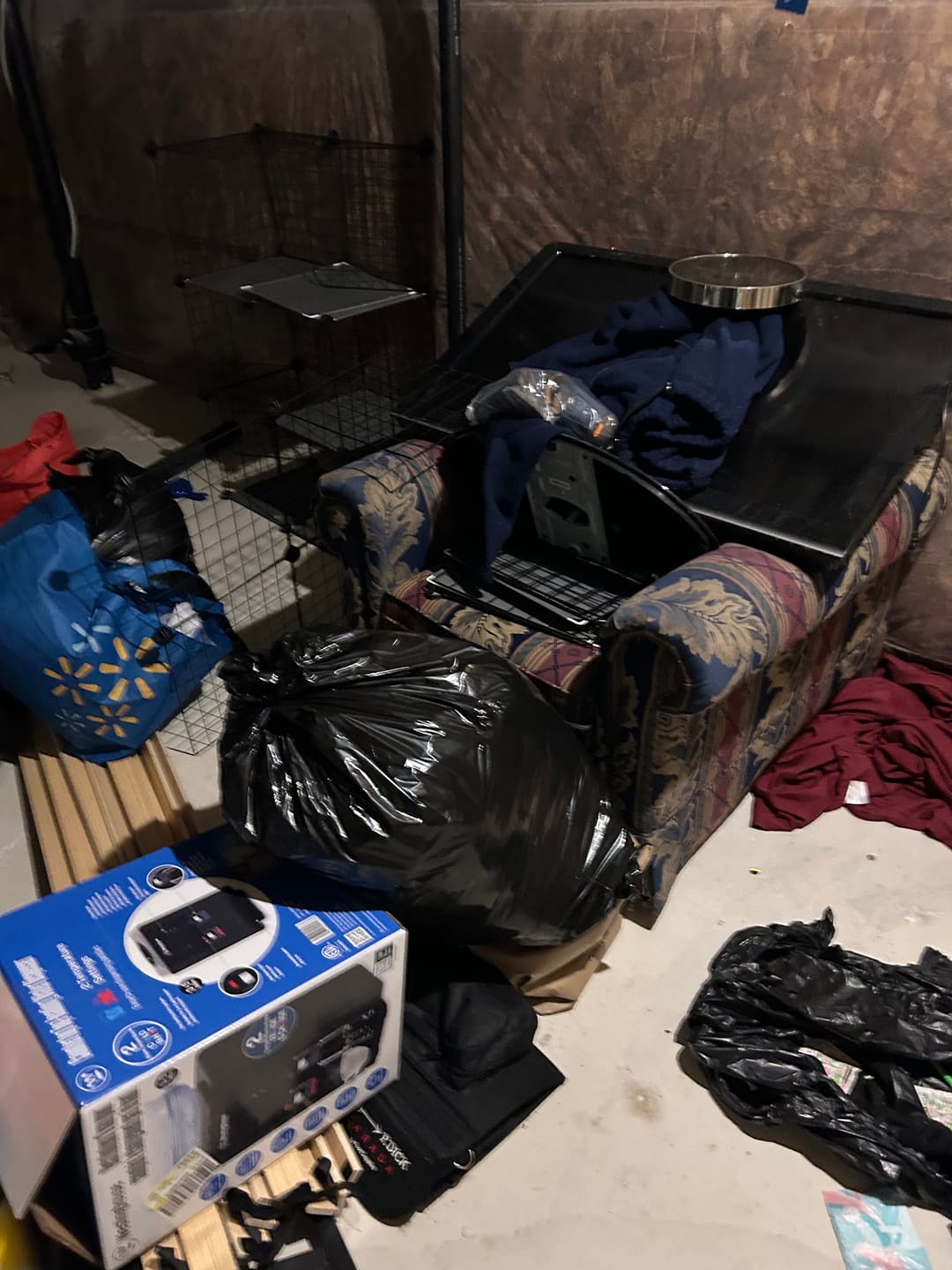 Bags, furniture and boxes piled in a basement