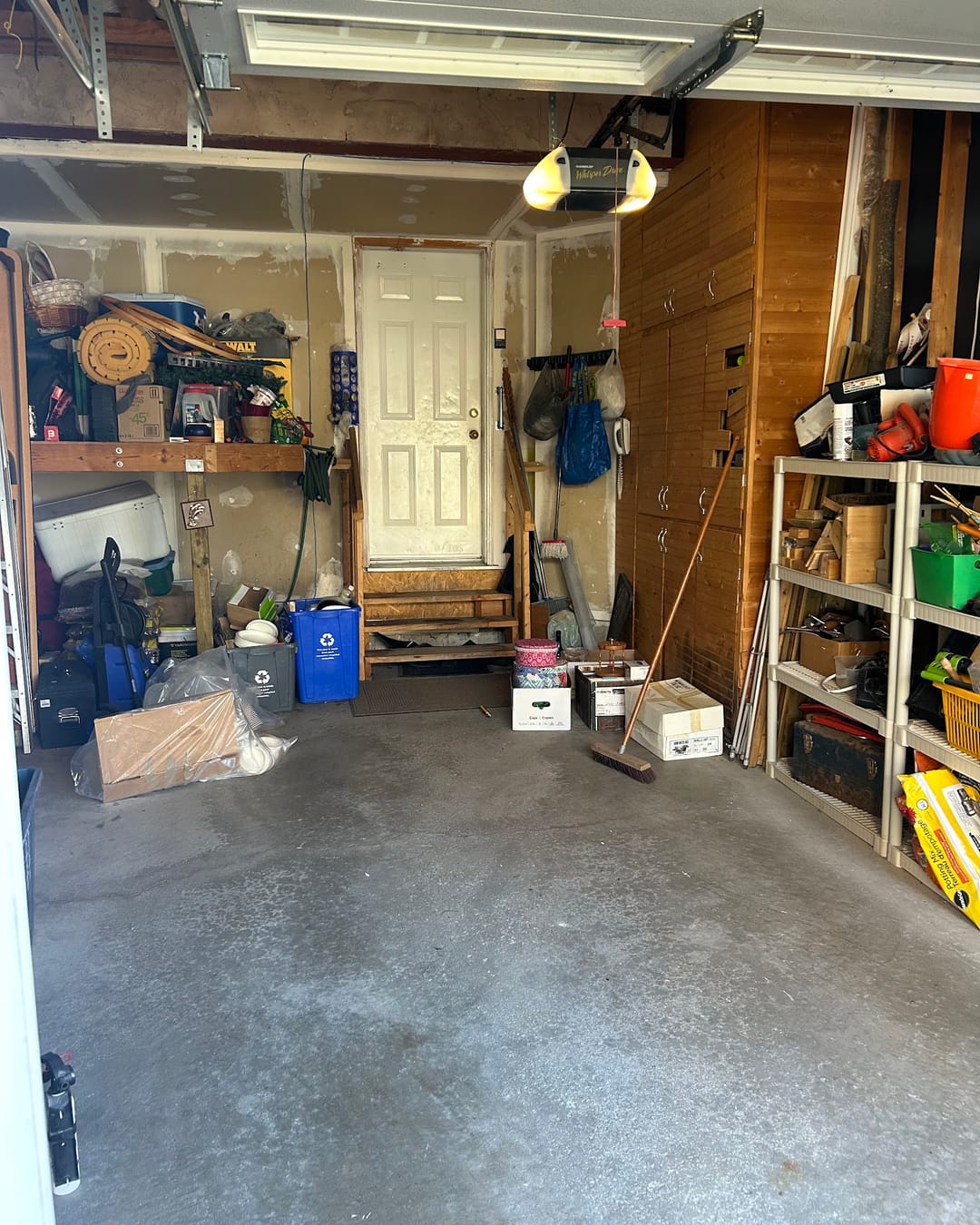 After: the same garage with the floor cleared and swept